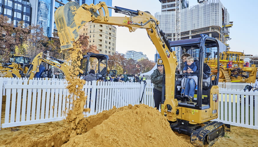 Families enjoying operating a Cat mini excavator at RTS 2021