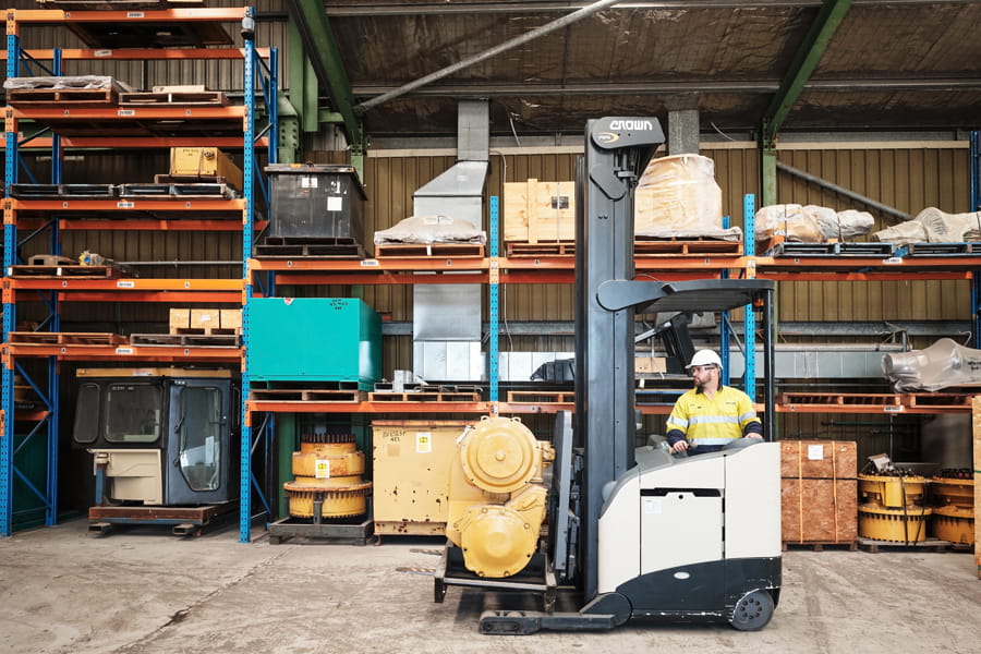 Employee driving forklift through WesTrac Mt Thorley warehouse