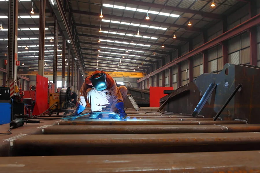 WesTrac employee welding in workshop