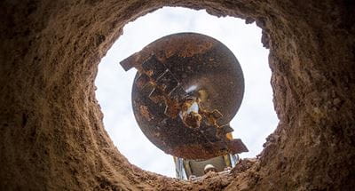 Cat Auger digs hole 