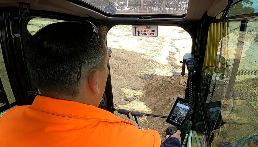 Operator inside Cat Mini Excavator
