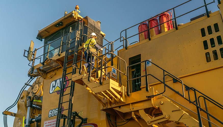 Operator entering Cat 6060 Cab