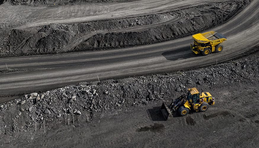 Cat Off Highway Truck near a Cat Motor Grader