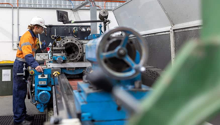 WesTrac Team Member using a lathe