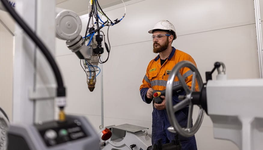 WesTrac Team Member using laser clad machine