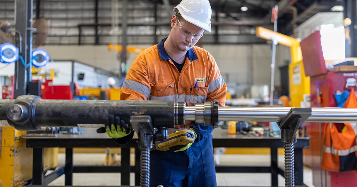 A WesTrac team member working on a hydraulic component