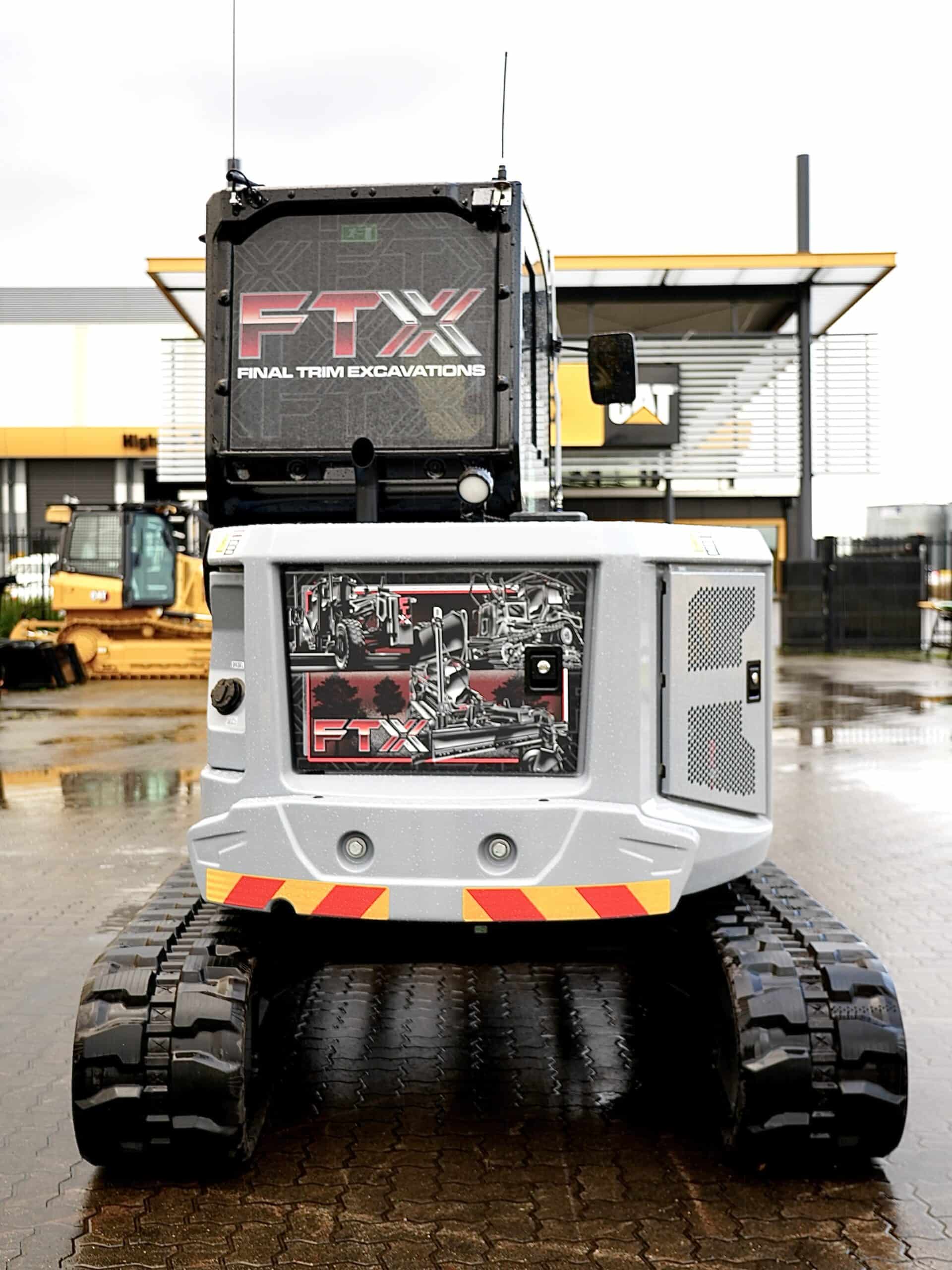 FTX Centennial Grey Cat Mini Excavator in front of WesTrac