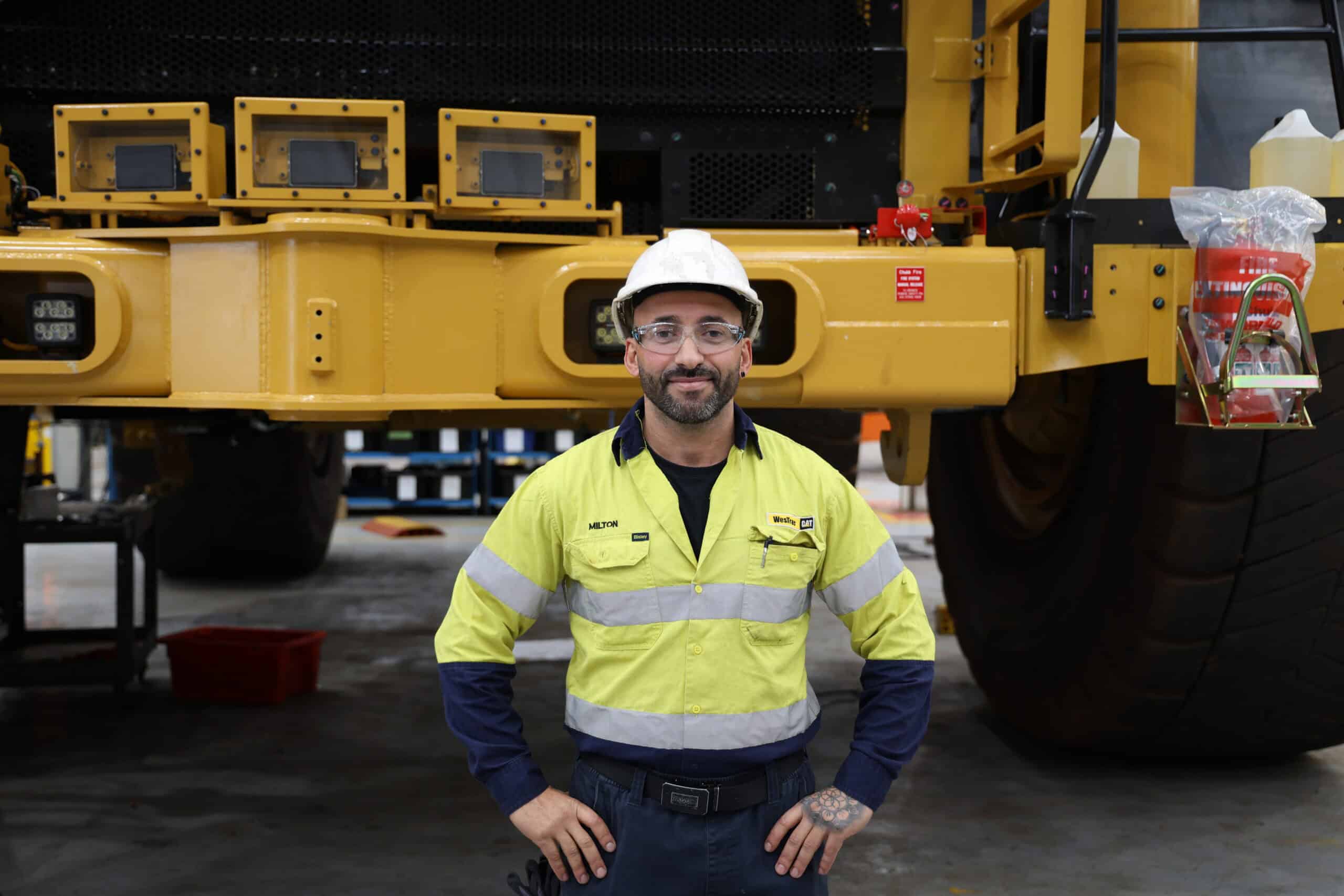 Milton De Freitas stands in front of machine
