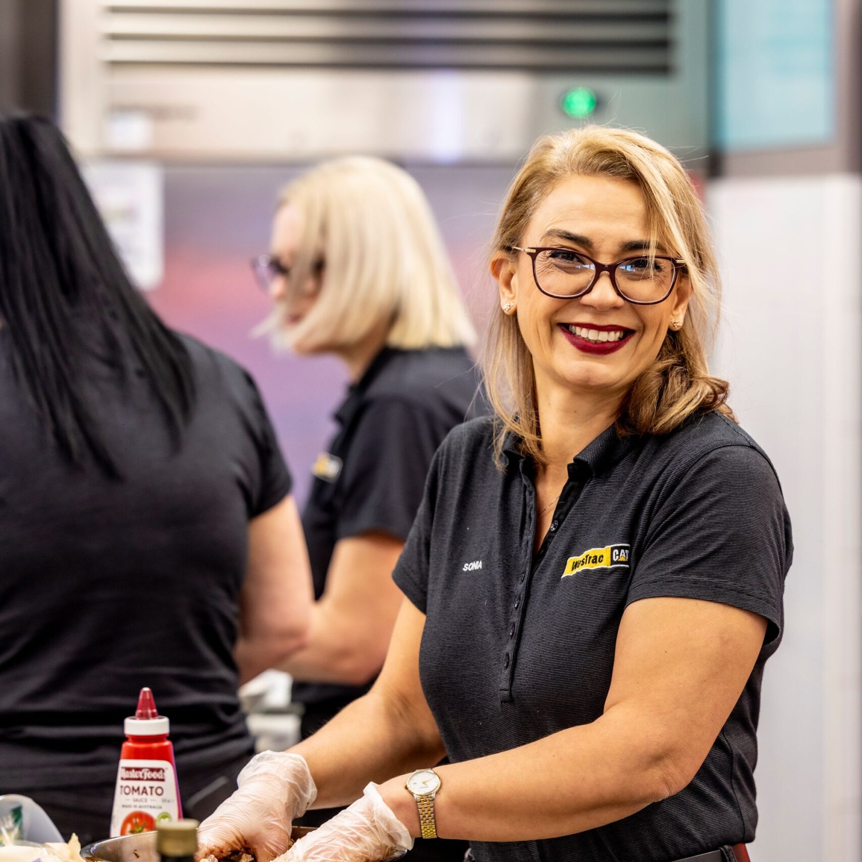 WesTrac team member serving food at community event in Northern NSW.